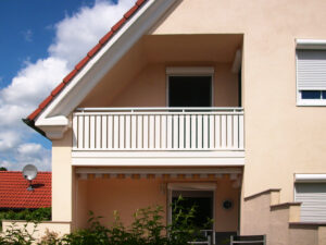 Rosa Einfamilienhaus mit Ziegeldach mit Alu Select Balkongeländer
